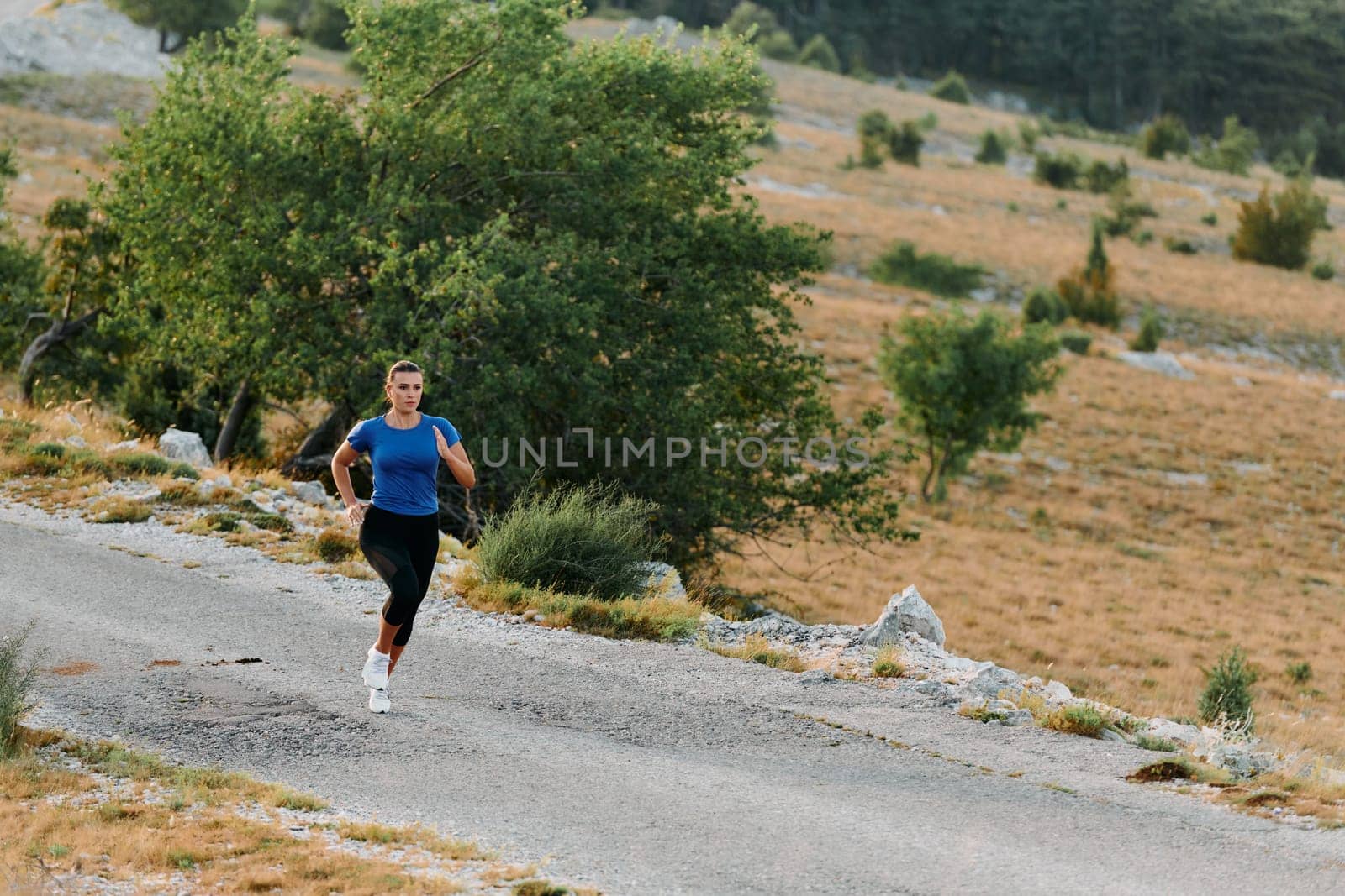 Empowered Runner Embracing Nature's Beauty on a Serene Morning Trail. by dotshock