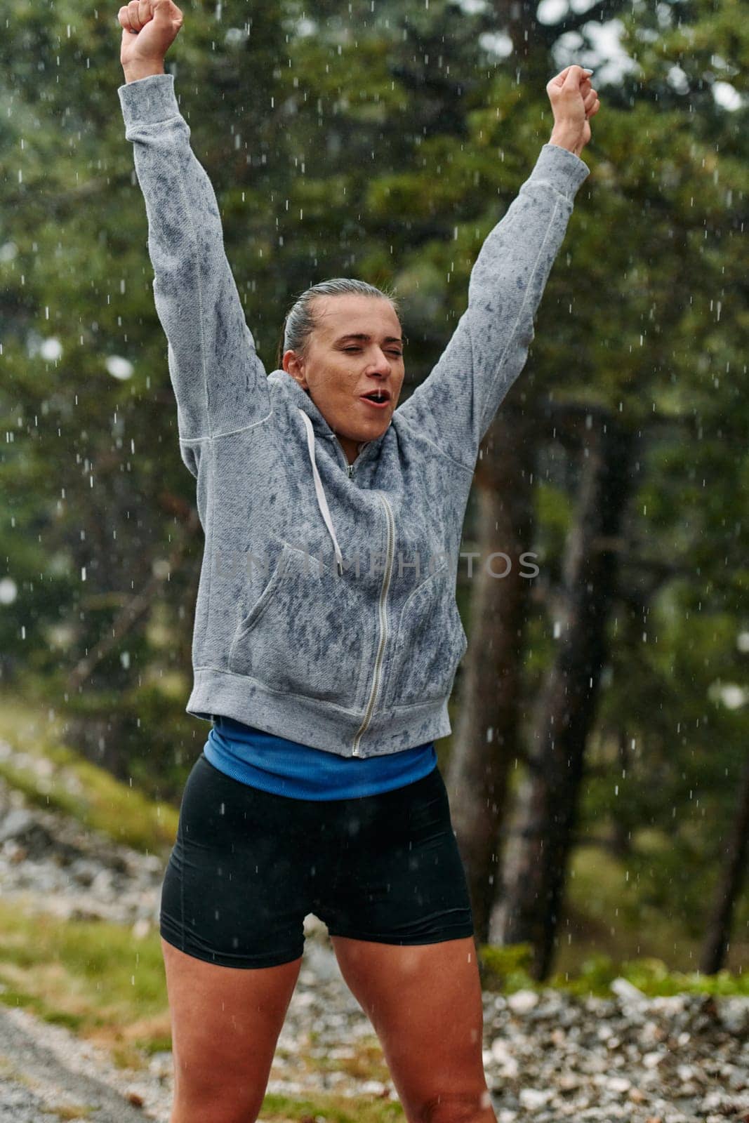 A stunning woman savors the tranquility of a rainy day after a rigorous run, finding solace and rejuvenation in the soothing rhythm of the falling rain.