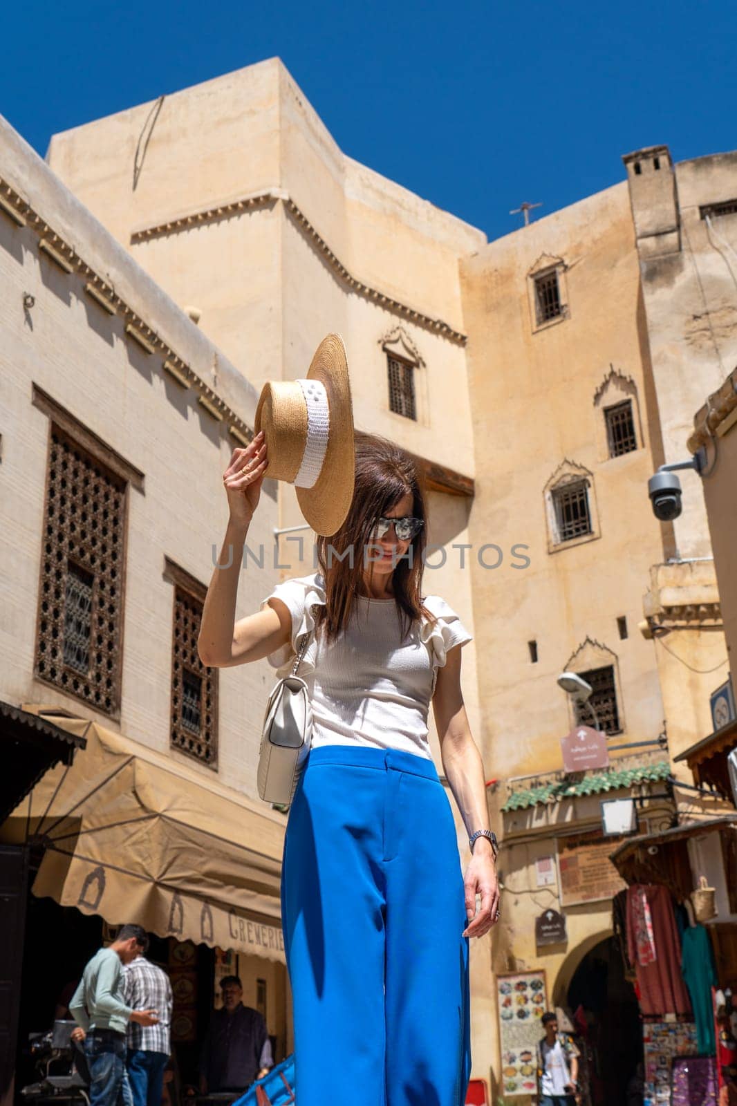 Young Woman in Hat at Nejjarine Square, Fez by LopezPastor