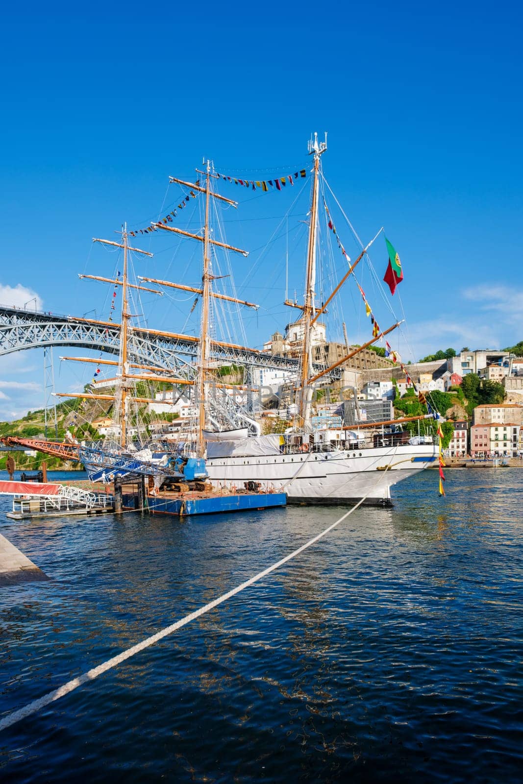 View of Vila Nova de Gaia city with a sailing ship and Dom Luis I bridge over Douro river. Porto, Portugal