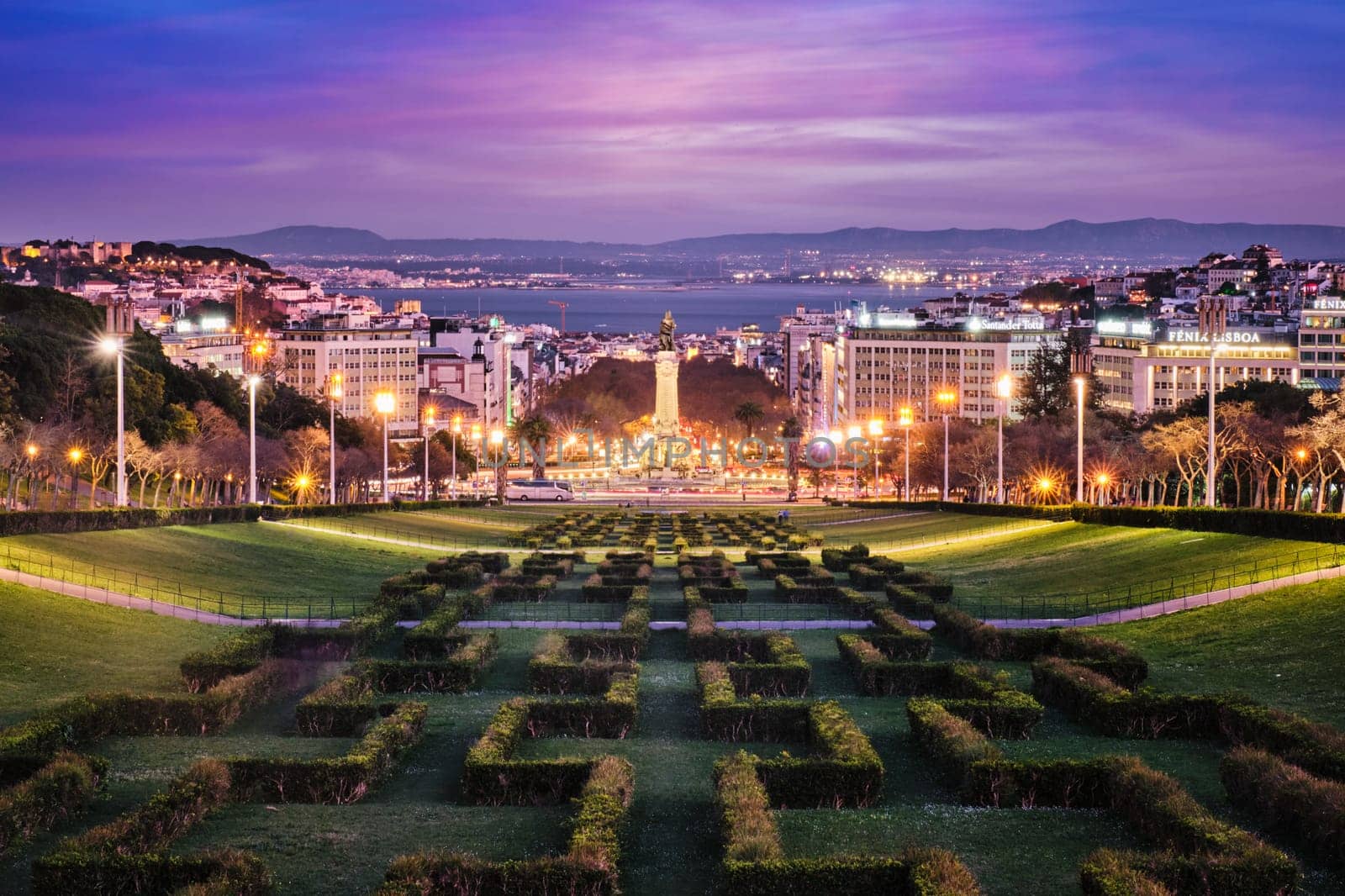 View of Lisbon Marquis of Pombal Square seen from the Eduardo VII Park in the evening twilight. Lisbon, Portugal