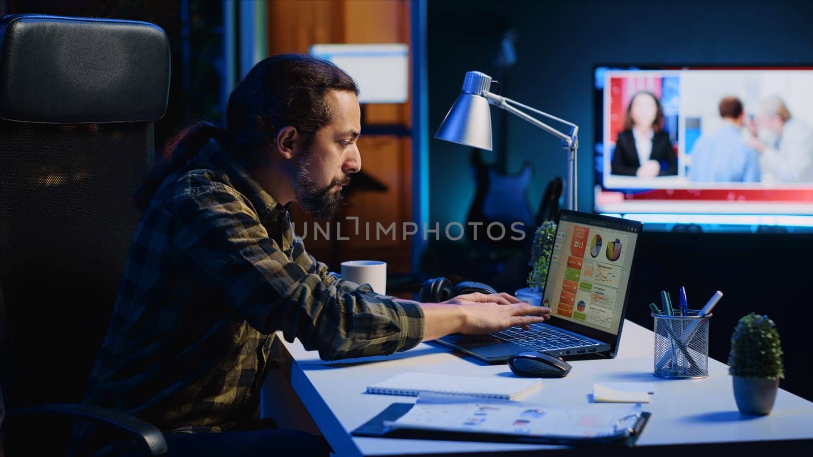 Man concerned about statistical data financial graphs on laptop screen while researching data for company project. Freelancer unhappy about business graphic figures, feeling stressed, camera A