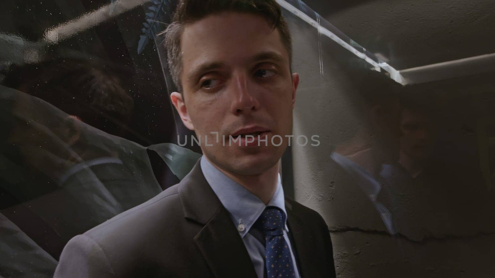 Business partners entering the glass facade elevator. Stock clip. Two young men in elevator, close up communication