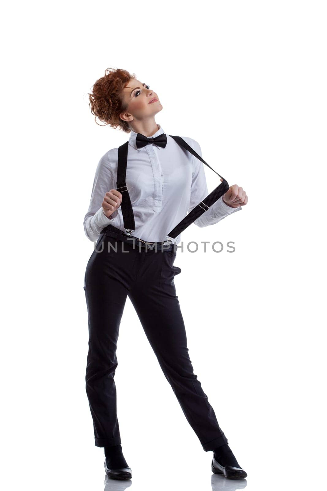 Flirtatious dancer dressed in formal suit. Isolated on white