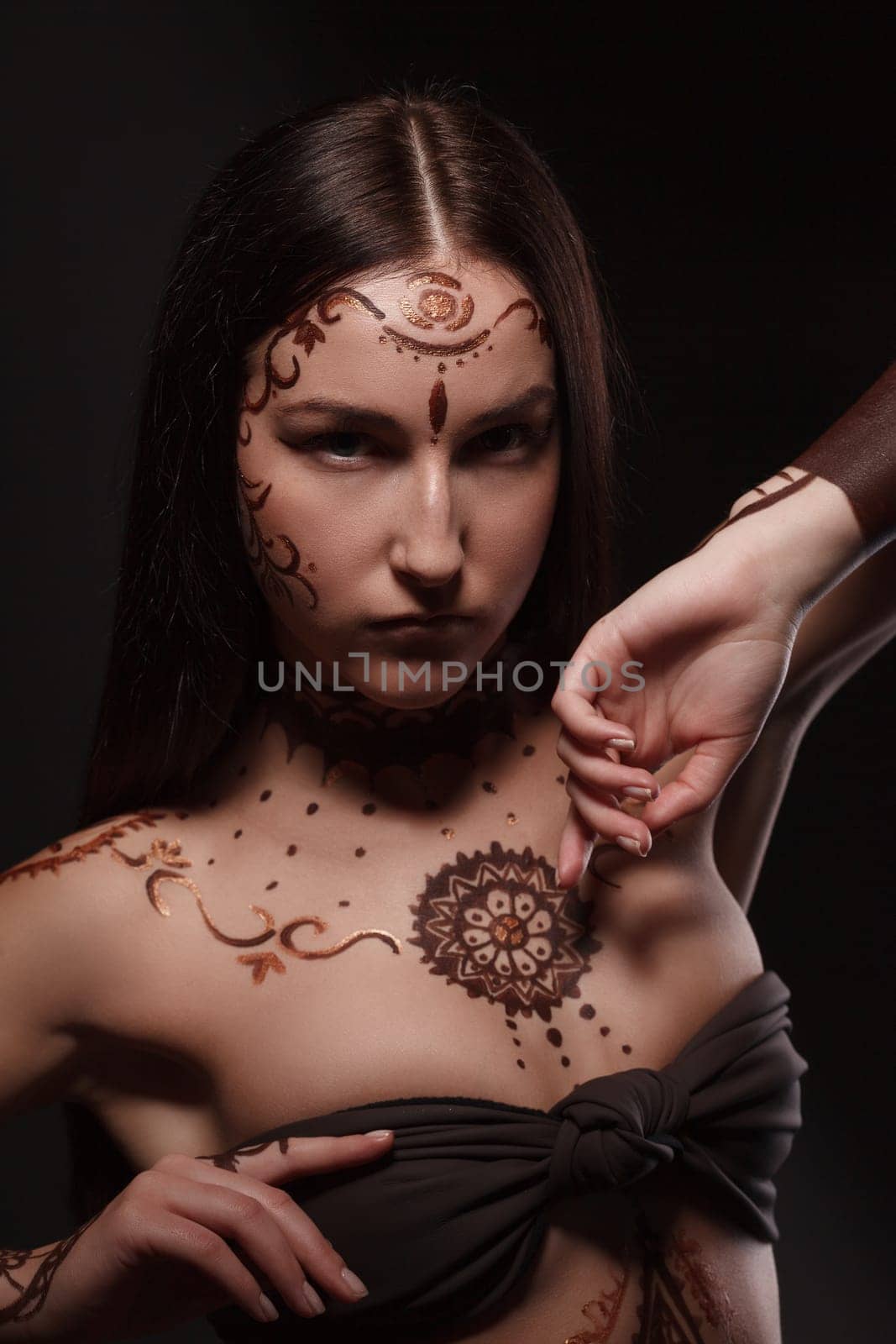 Mehendi. Studio portrait of brunette with exotic appearance