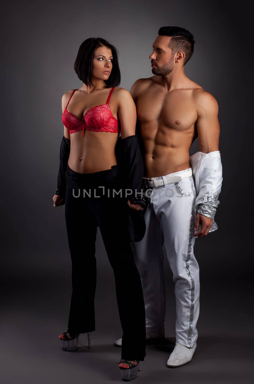 Striptease show. Image of sexy couple posing in studio