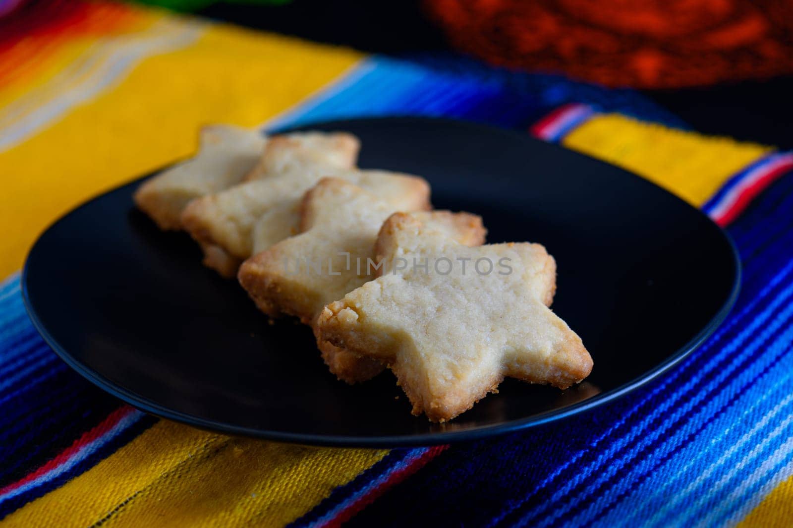 Star shaped Scottish shortbread biscuits, sweets and confectionery. Four delicious sweet sugar cookies lined up on a plate.