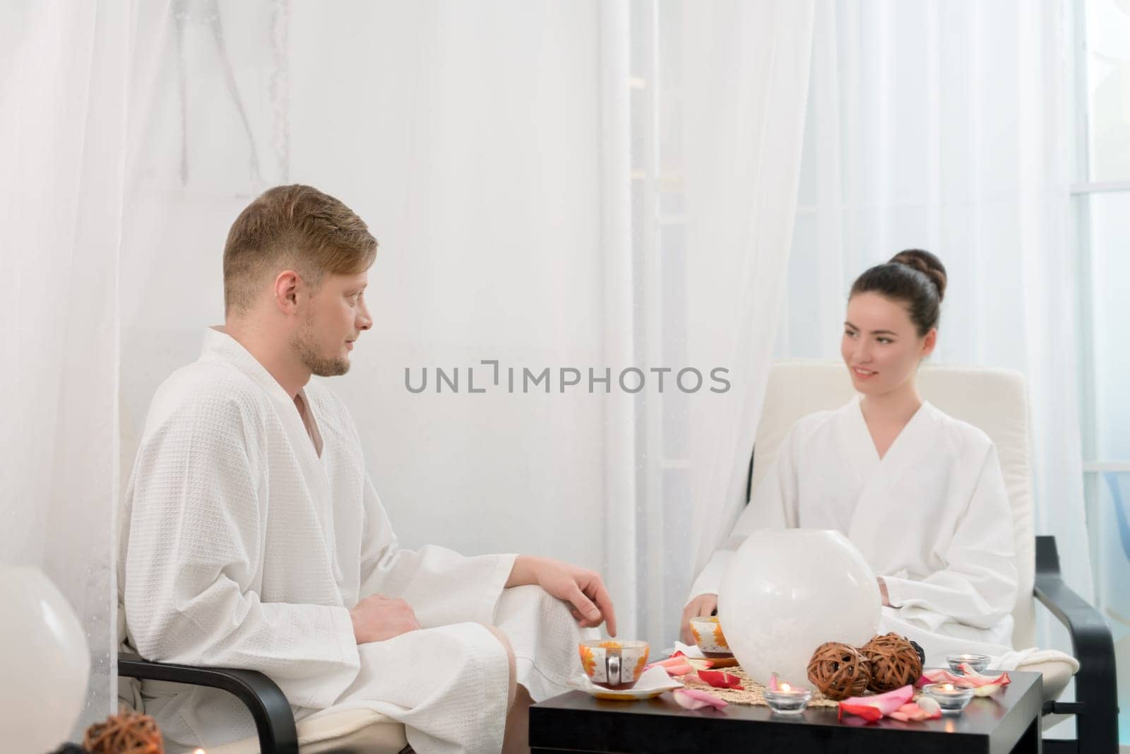 Photo of attractive man and woman relaxing in spa salon