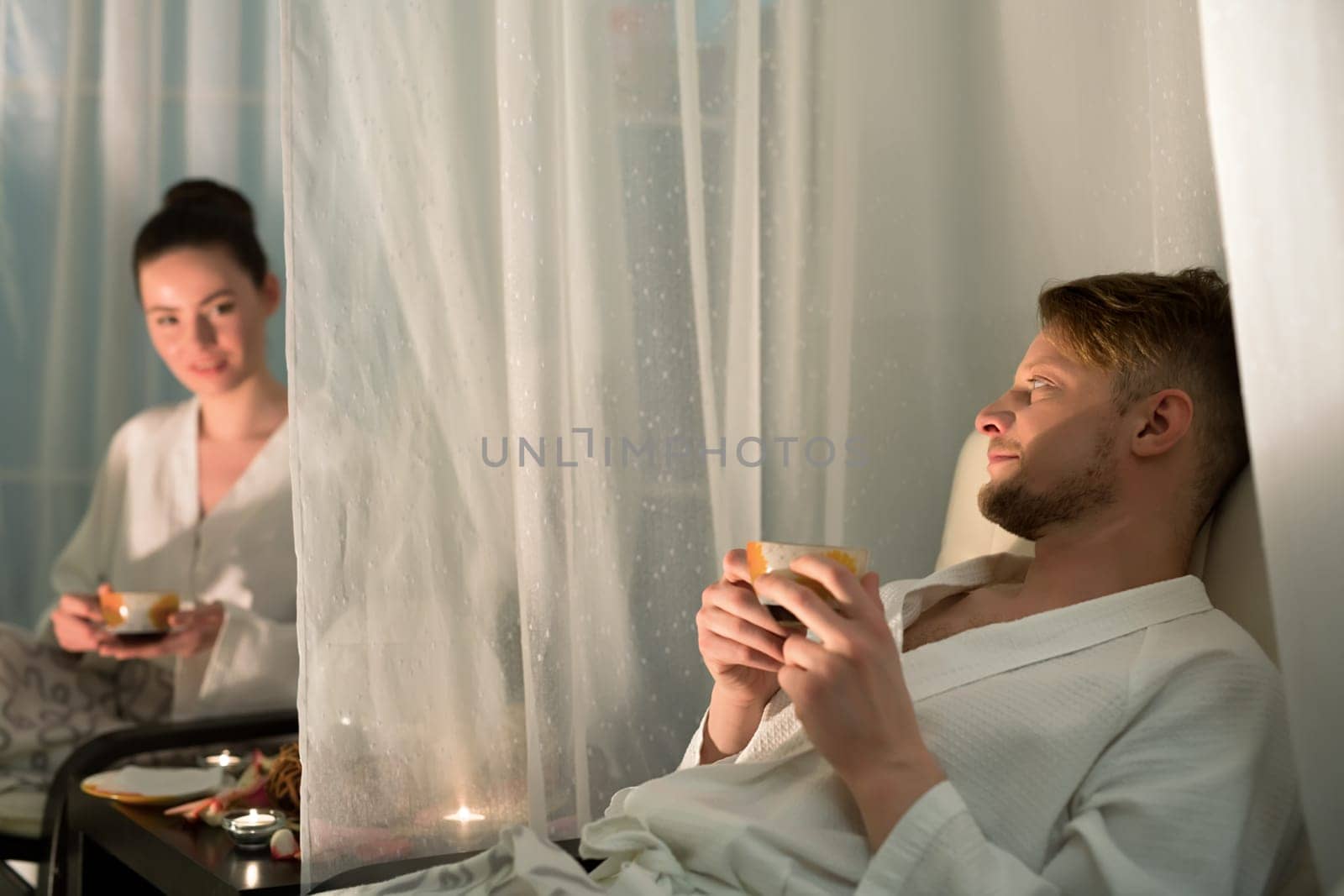 Photo of young couple relaxing in wellness center