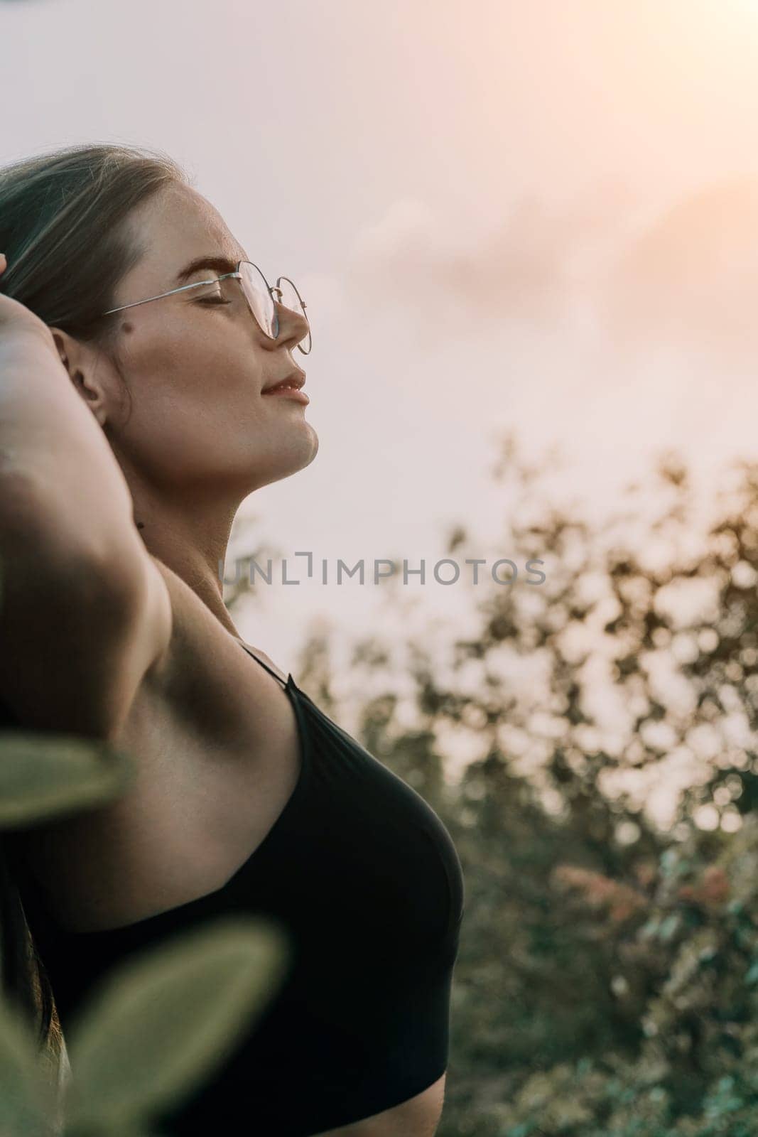 Woman travel sea. Young Happy woman in a long red dress posing on a beach near the sea on background of volcanic rocks, like in Iceland, sharing travel adventure journey