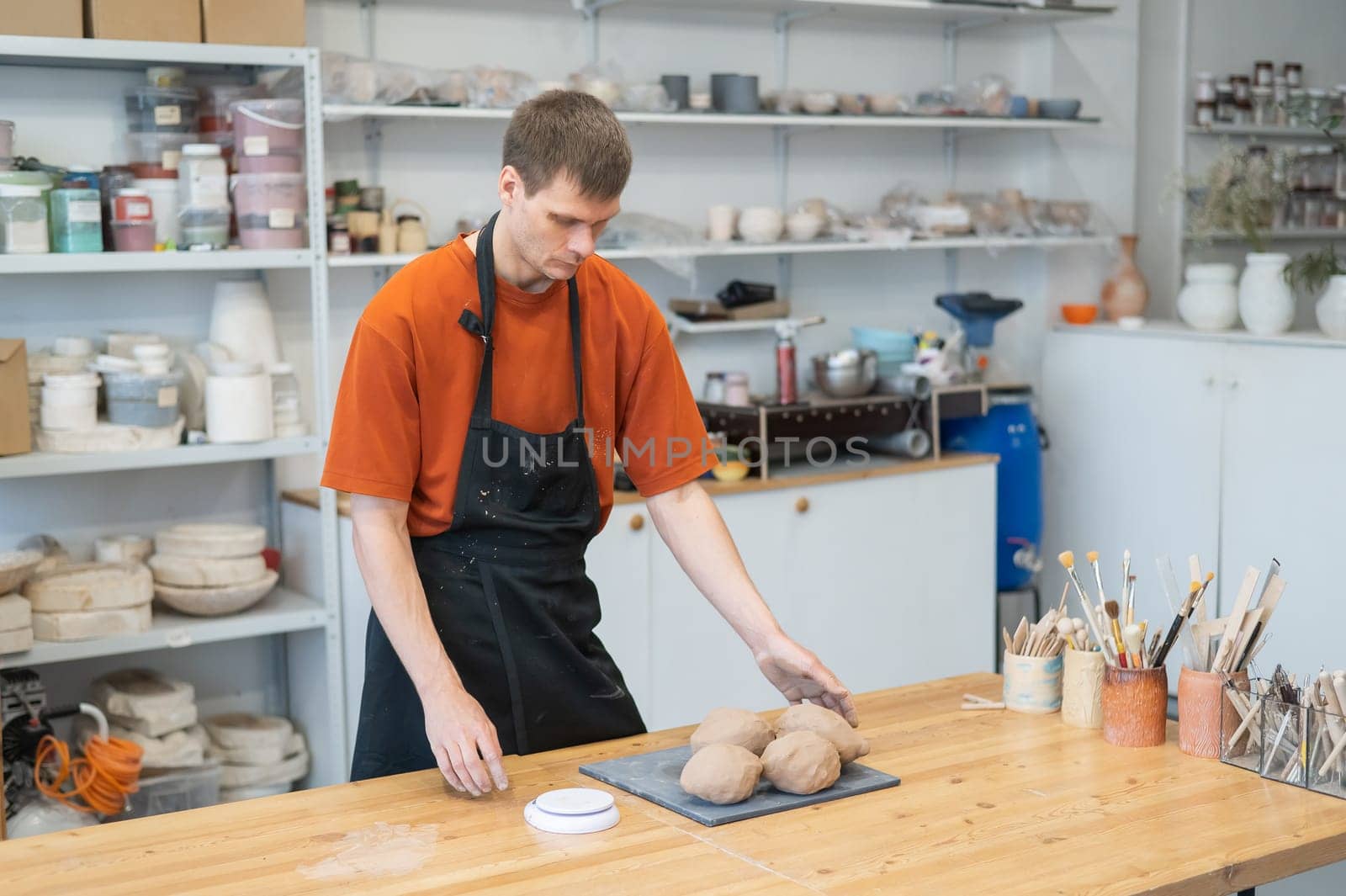 Potter kneads clay before using it in the workshop