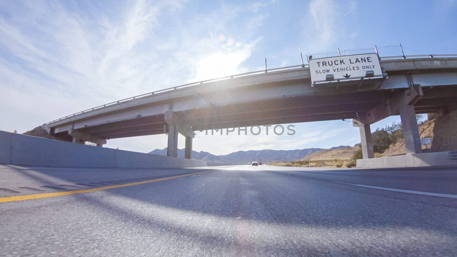 Embarking on a road trip from Nevada to California, driving on Highway 15 during the day offers scenic views and an exciting journey between states.