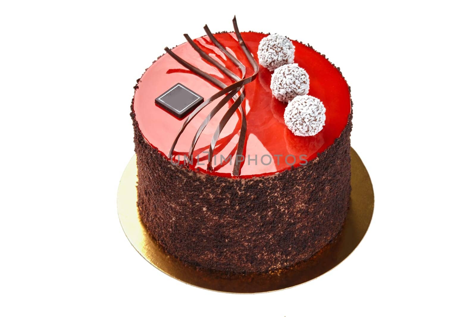 Exquisite cake adorned with red mirror glaze, chocolate streusel, artistic swirls and coconut covered truffles on gold base. Concept of confectionery craftsmanship