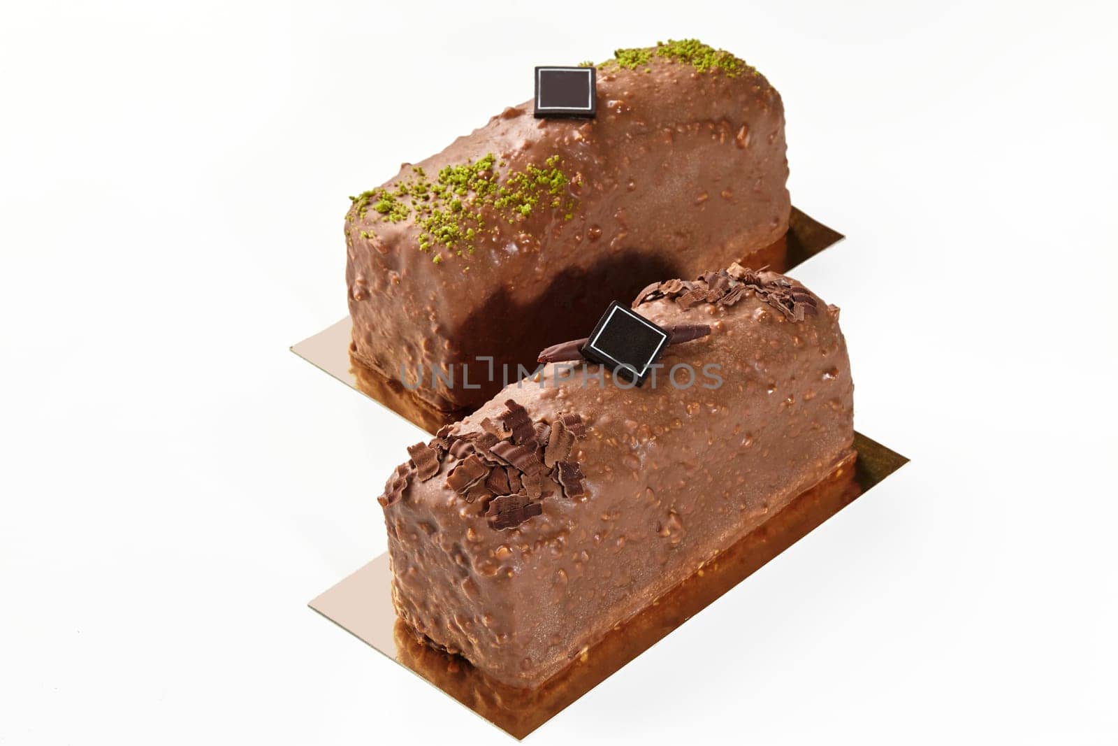 Artisanal sweet nutty chocolate cake bars on white background by nazarovsergey