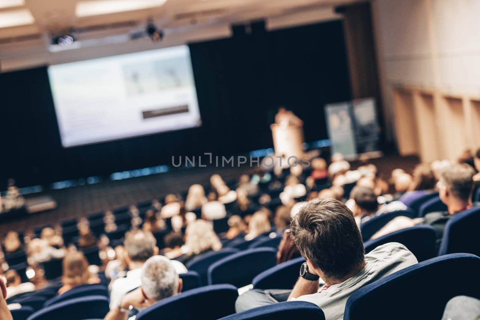 Speaker giving a talk on scientific conference. Audience at the conference hall. Business and Entrepreneurship concept. by kasto