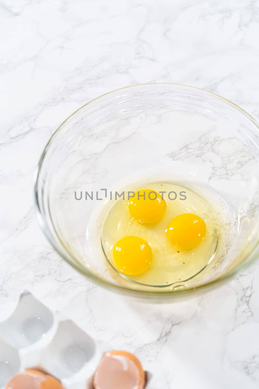 Measured ingredients in glass mixing bowls to bake American flag mini cupcakes.