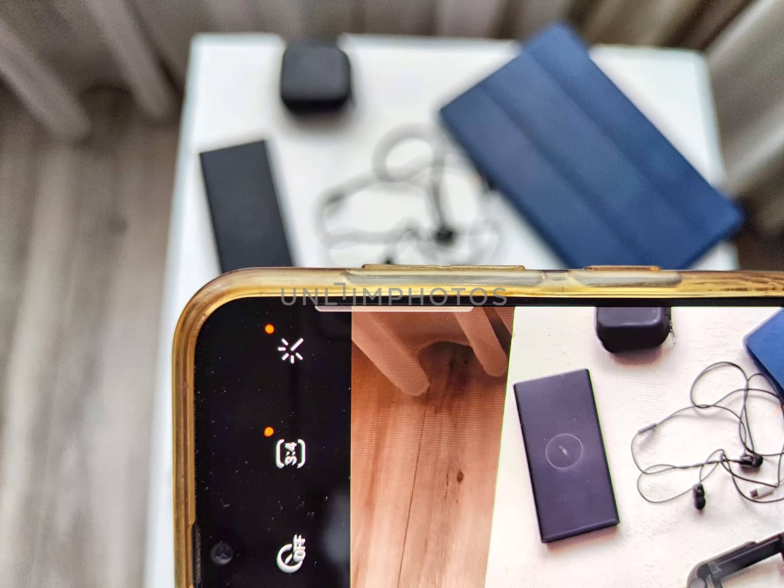 Hands of Senior woman Capturing Tech Gadgets With Smartphone. Elderly blogger take close-up shot of electronic accessories