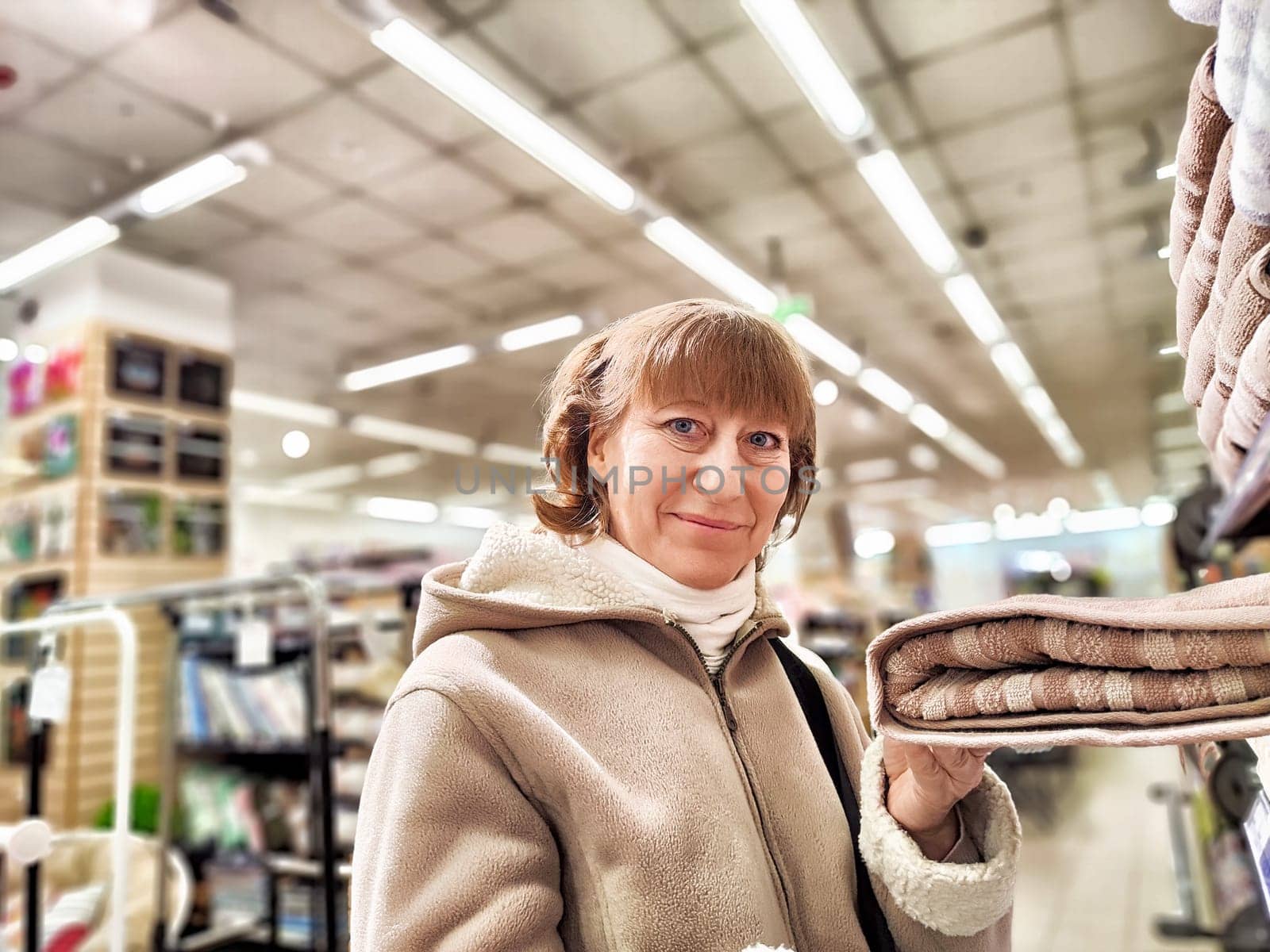 Girl while shopping in a store. A middle-aged woman chooses shopping on the trading floor