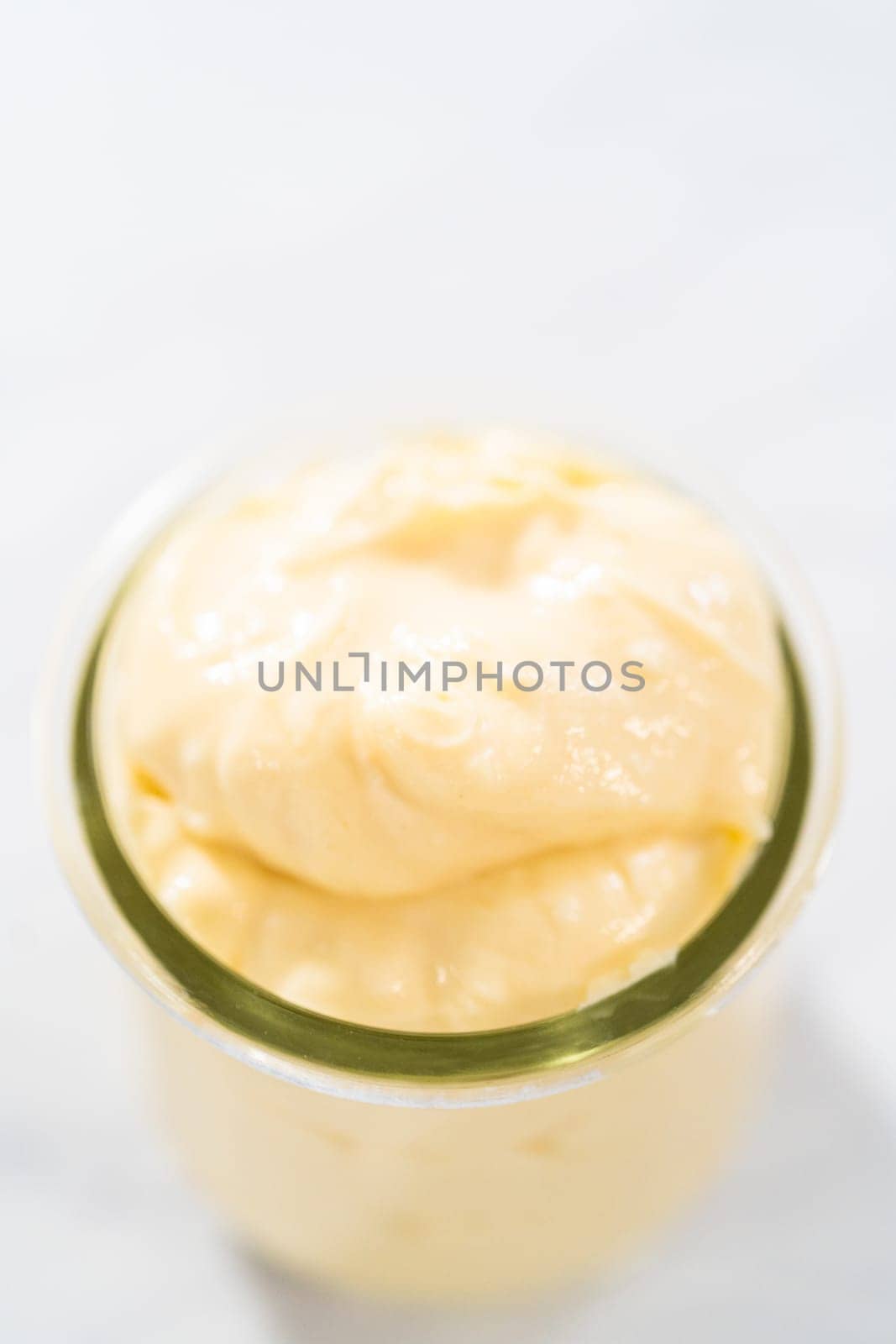 Cream cheese filling for bundt cake in small glass jat.