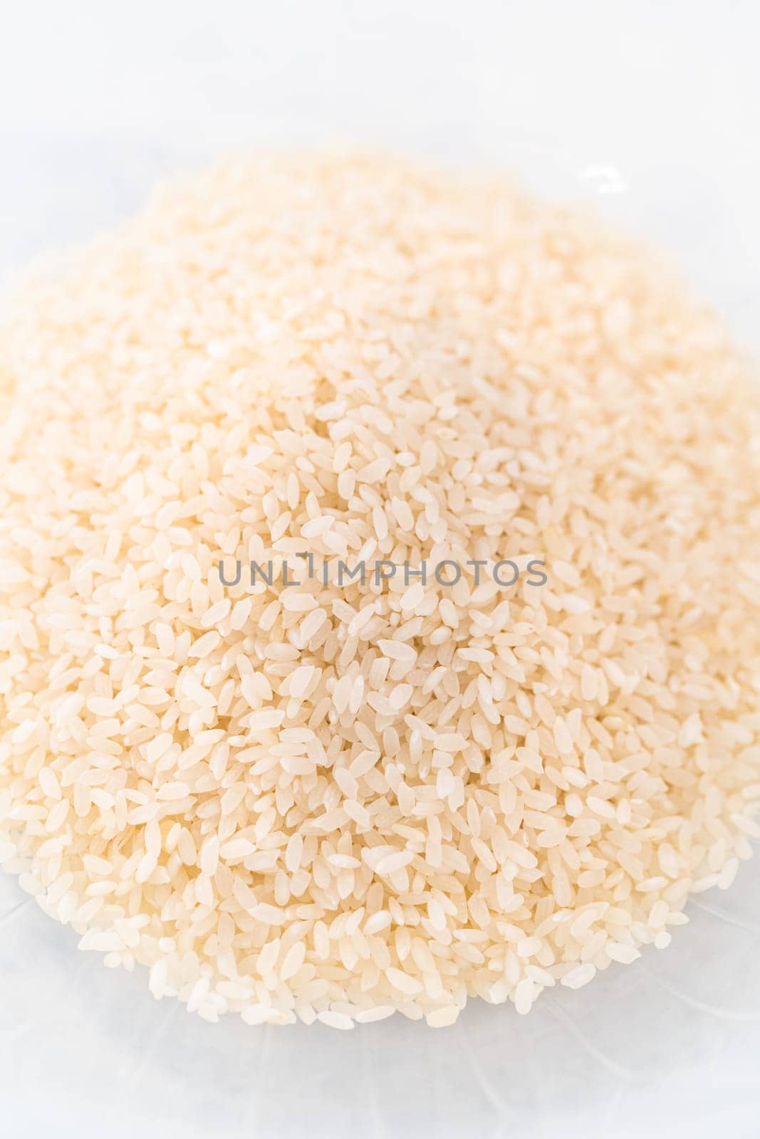 Washing dry rice in a rice washer and large glass bowl.