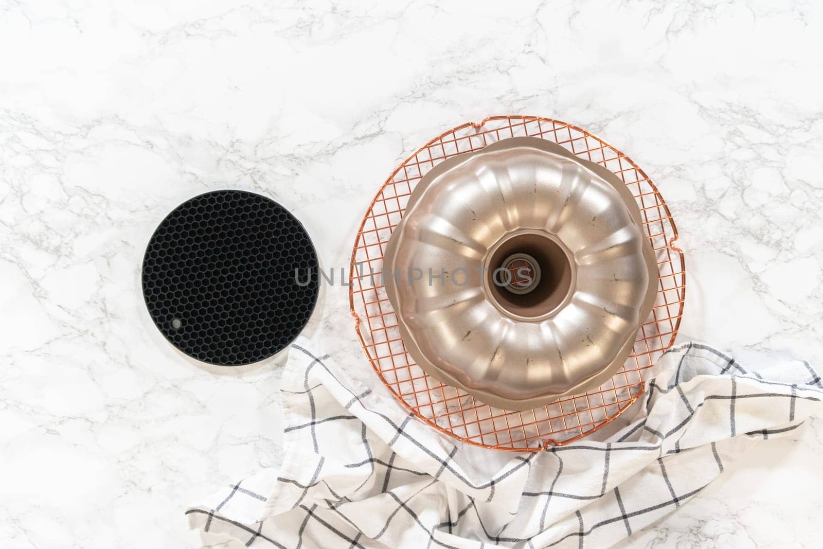 Flat lay. Cooling freshly baked pumpkin bundt cake on the kitchen counter.