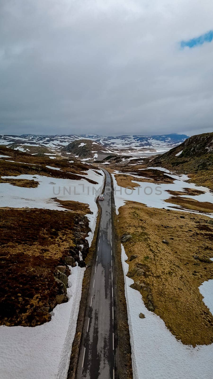 Campervan or motorhome travel camper van, Caravan trailer, or camper RV at the Lyse road covered with snow to Krejag Norway Lysebotn, road covered with snow