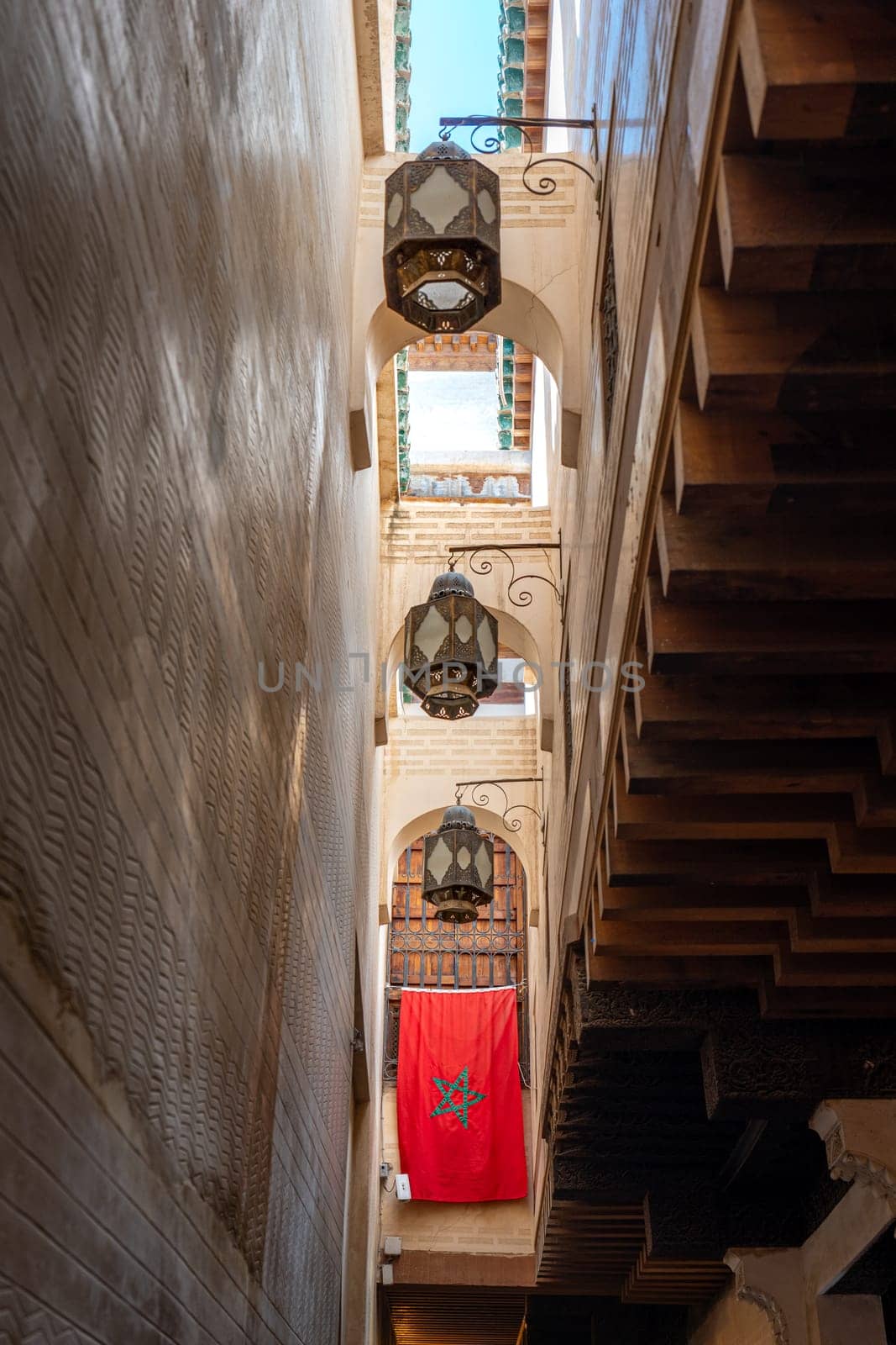 Narrow Street with Moroccan Flag, Upward View in Fez Medina, Morocco