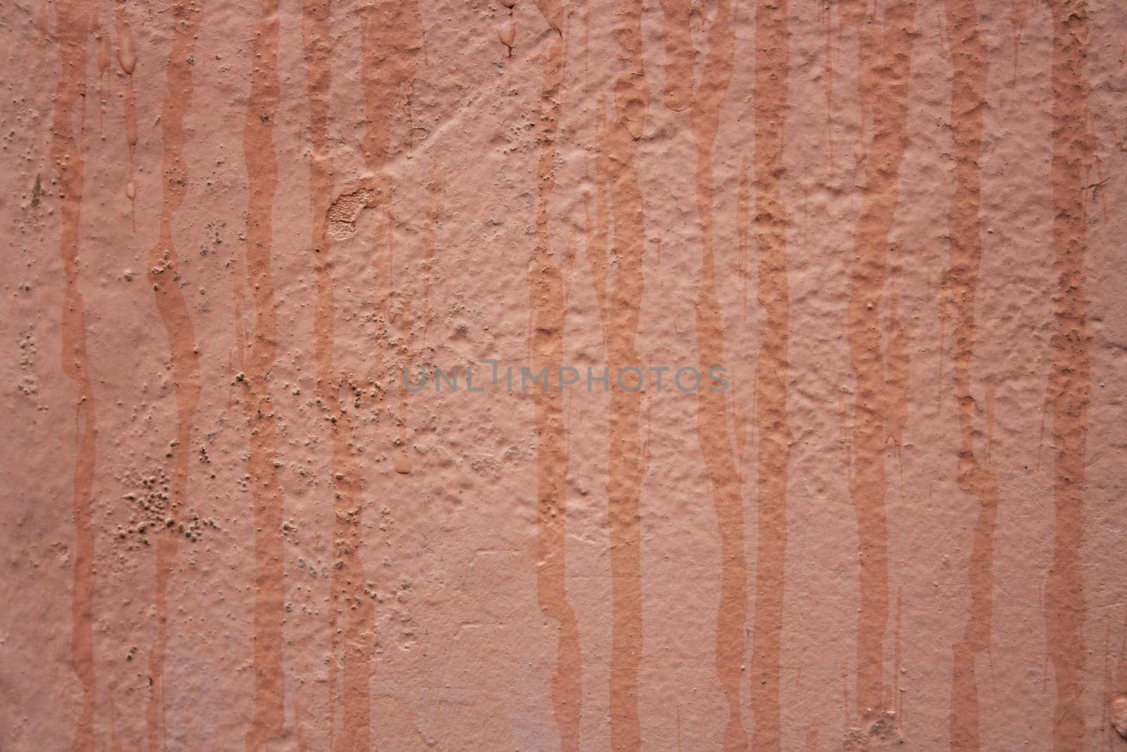 Horizontal view of textured urban background in peach fuzz color. Vintage wall with texture.