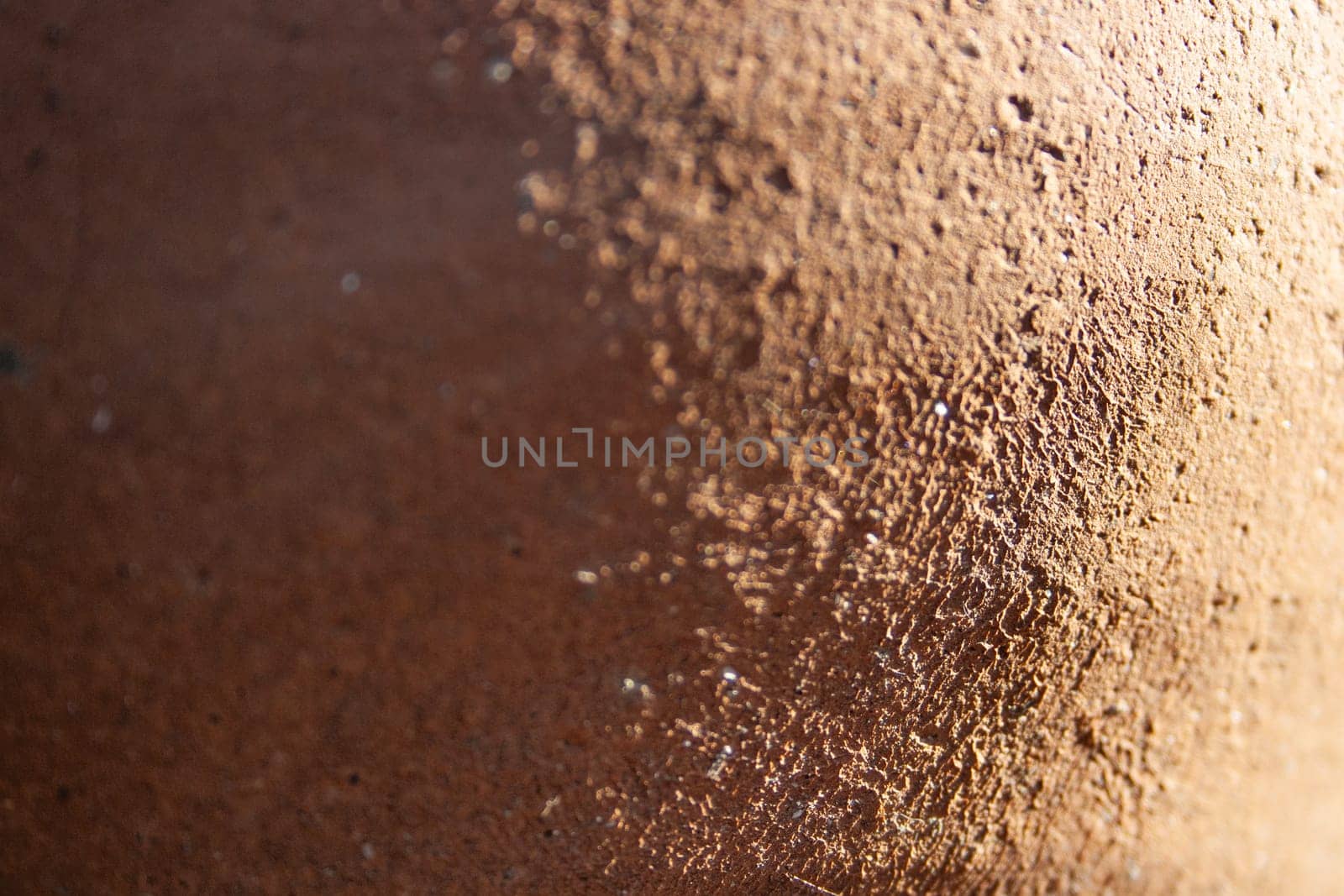 Horizontal view with shadows of a vintage wall with texture. curve wall light orange pastel color with rustic cement texture.Copy space