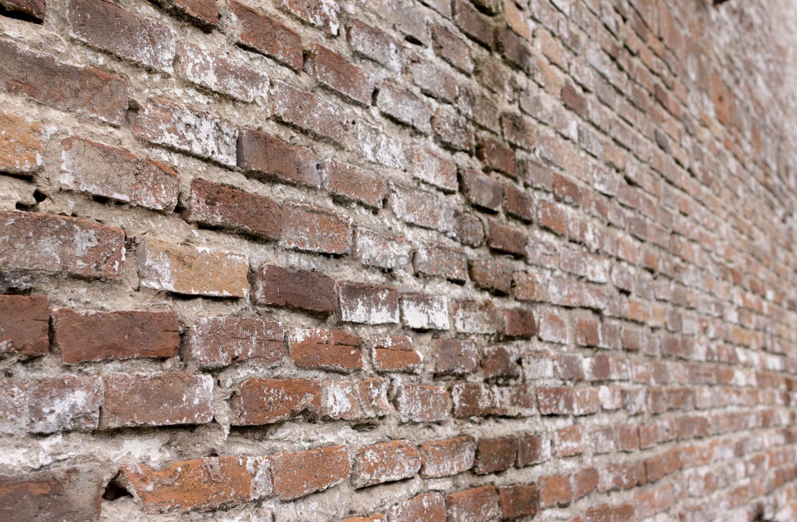 Perspective view of a wall with red aged bricks Old urban textured background by VeroDibe