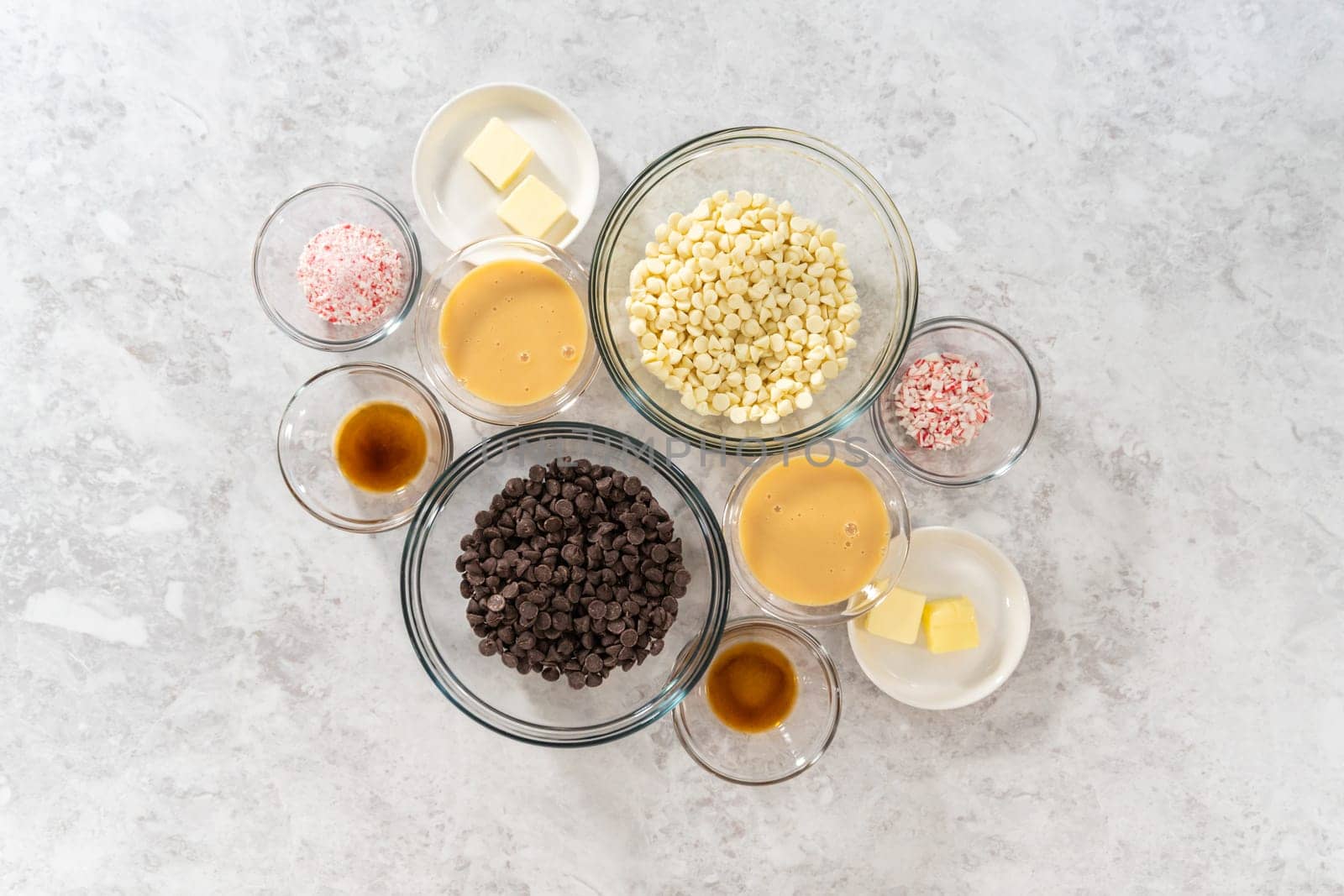 Flat lay. Measured ingredients in glass mixing bowls to make candy cane fudge.