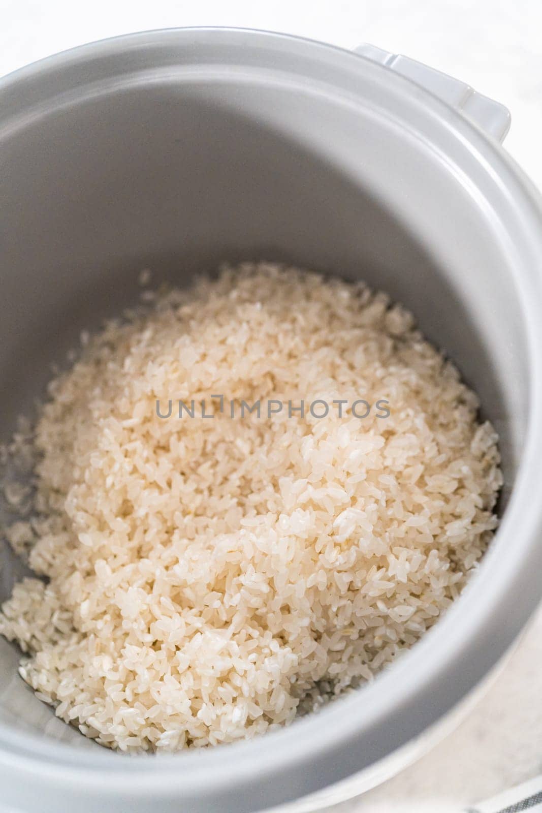 Cooking white rice in a rice cooker.