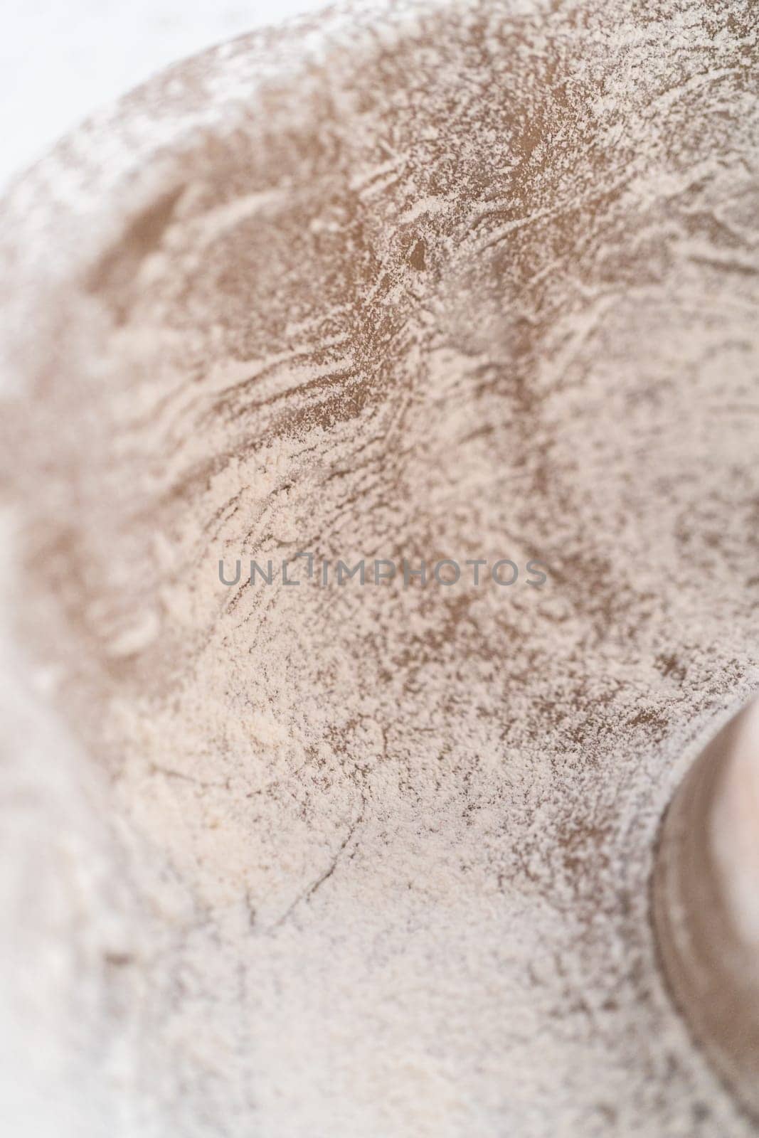 Greasing metal bundt cake pan to bake a simple vanilla bundt cake.