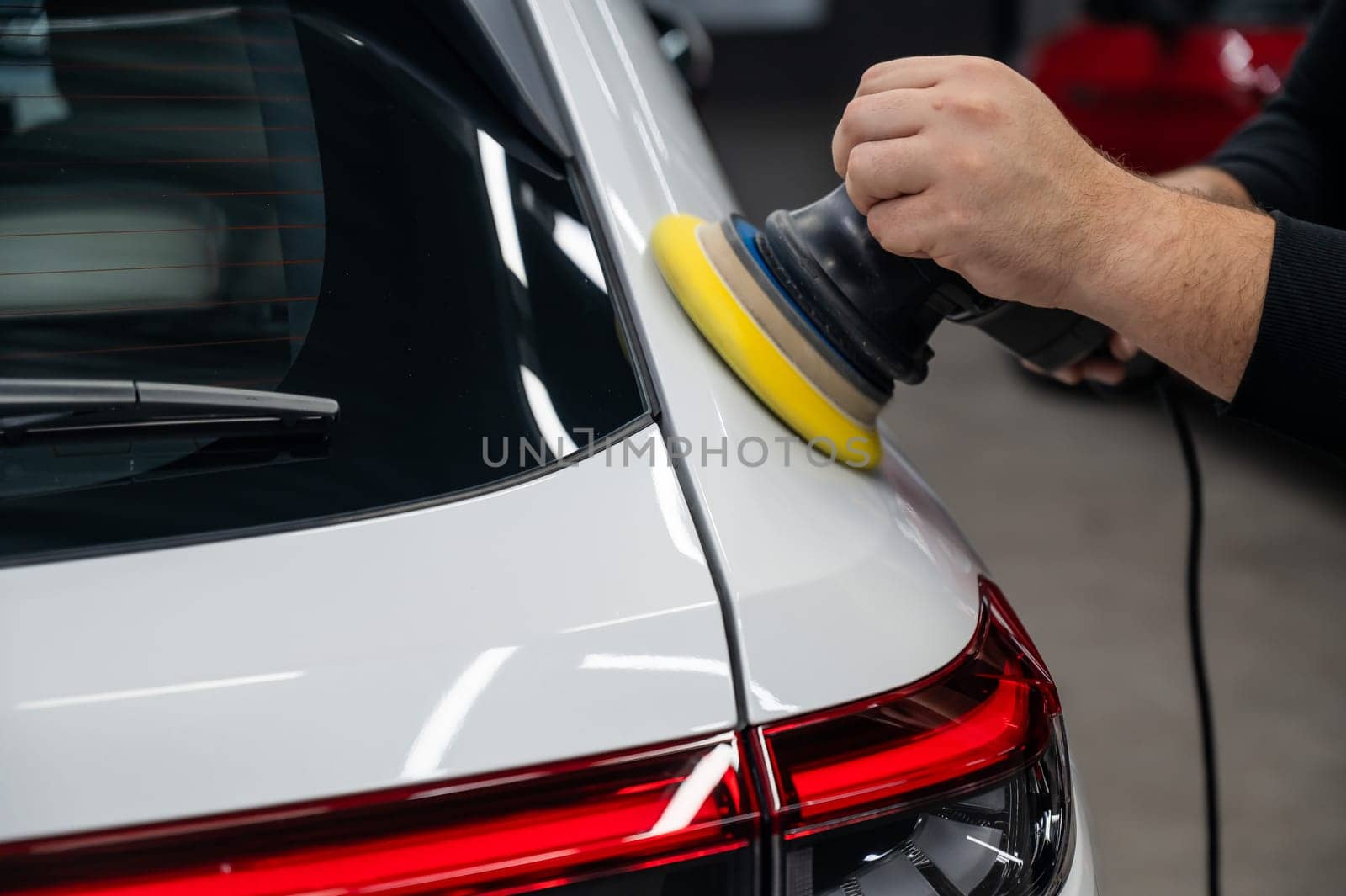 Process of polishing white car body surface using orbital polishing machine. by mrwed54