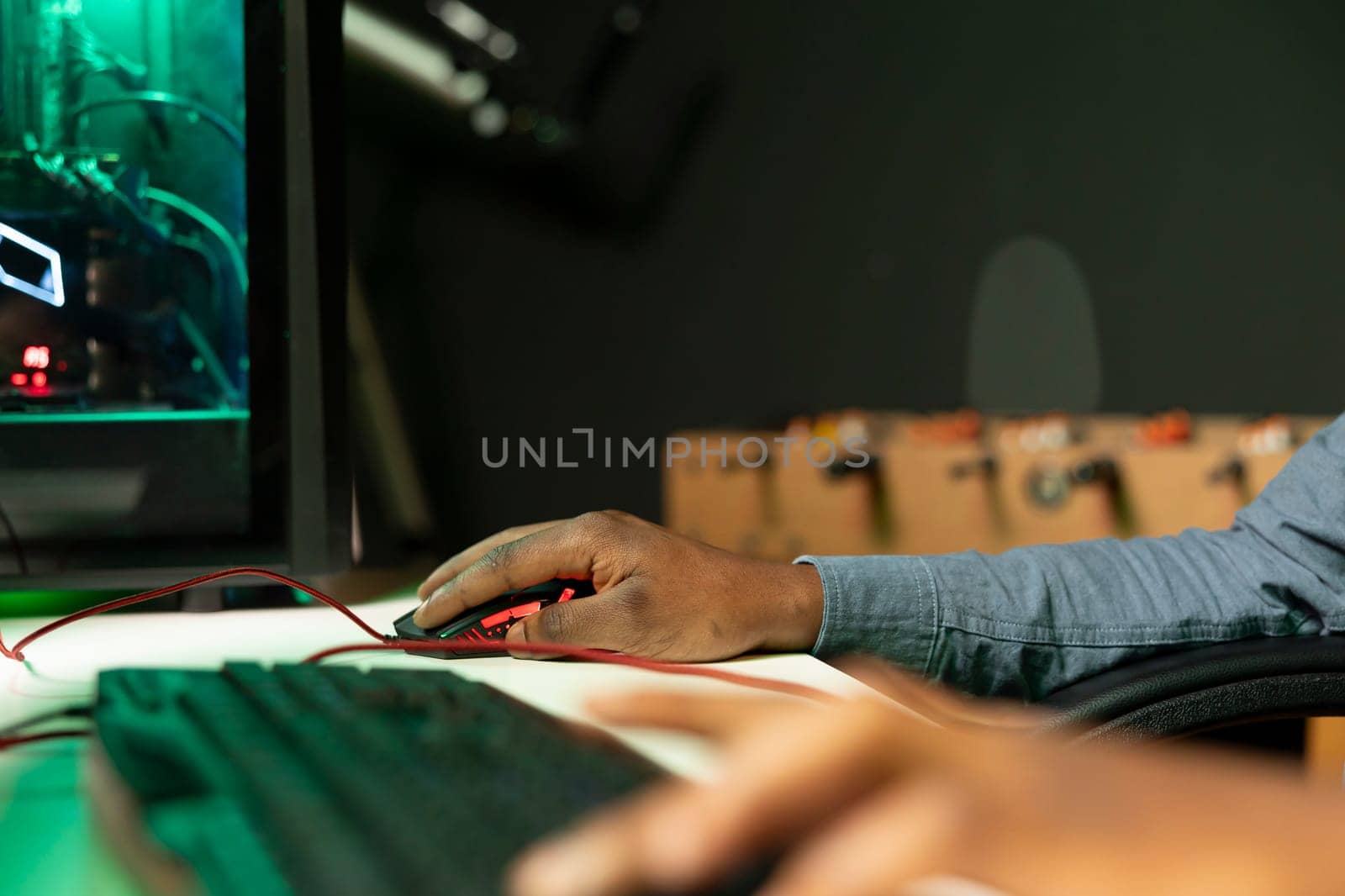 Gamer using keyboard and mouse to play FPS singleplayer videogame on PC, enjoying leisure time. Person in apartment at night using high tech computer peripherals to destroy enemies, close up