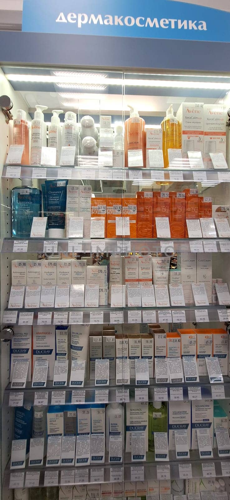 Bobruisk, Belarus - May 1, 2024: A selection of Avene sunscreens, hand creams, and skincare products neatly arranged on pharmacy shelves.