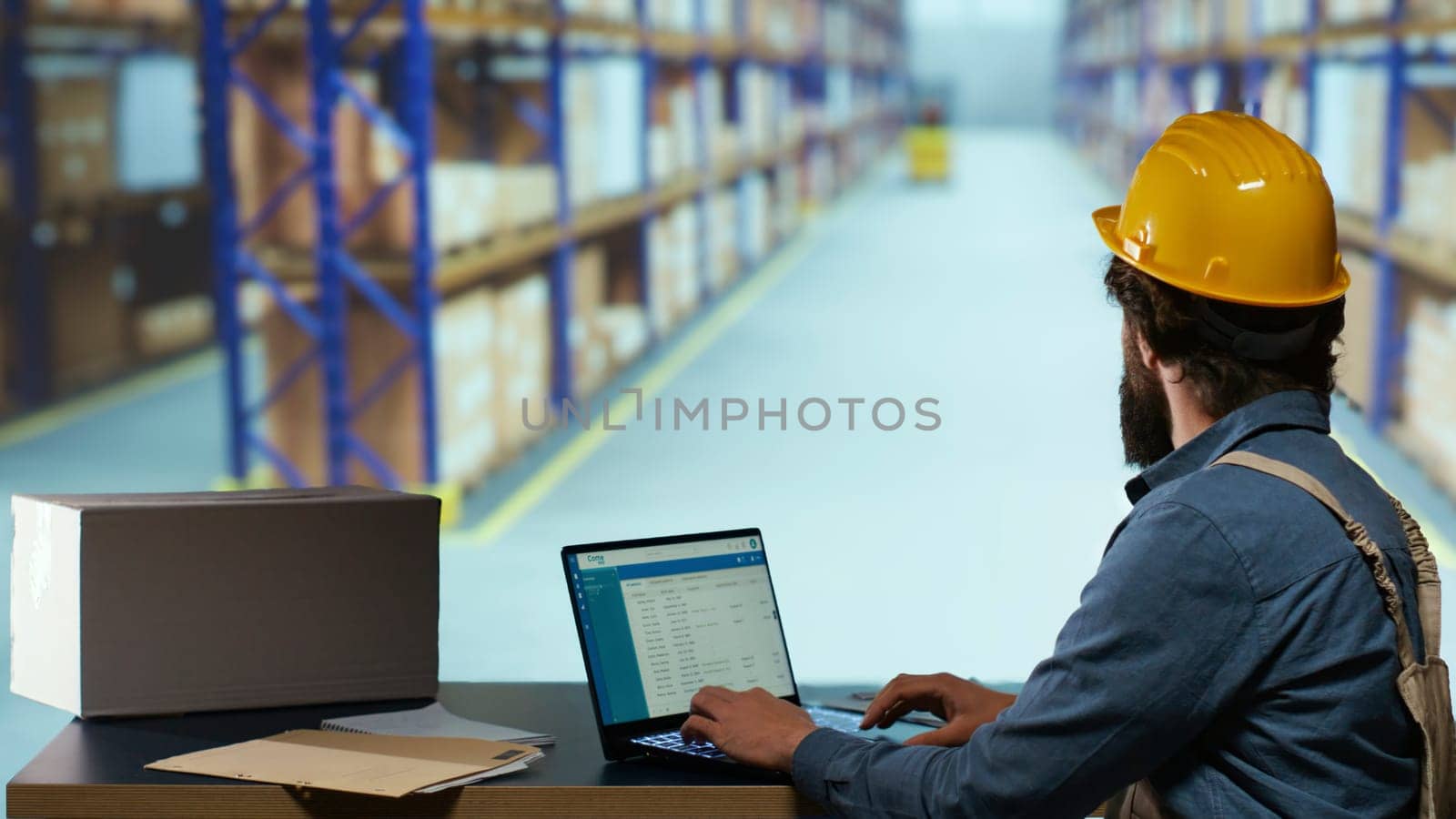 Packaging technician uses QR code reader on laptop to guarantee deliver for all merchandise ordered. Employee of the shipment inspection team examines consignment labels at import/export depot.