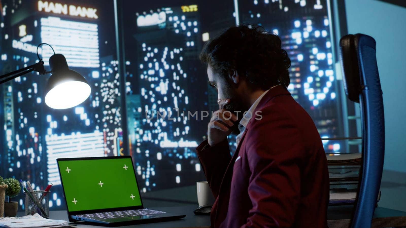 Legal investor works with greenscreen on pc at workstation by DCStudio