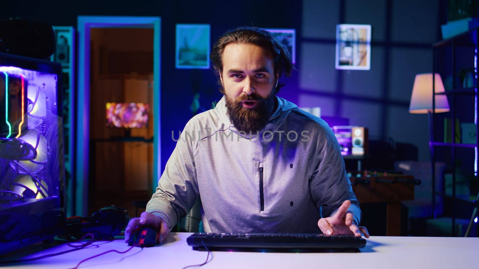 Content creator turning gaming chair around, greeting audience, filming tutorial on how to defeat enemies in multiplayer game. Pro gamer playing videogame, teaching viewers esports strategies