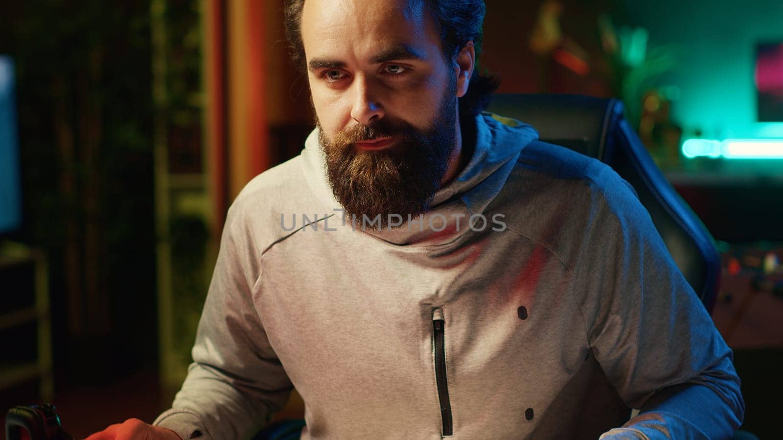 Close up shot of focused man playing videogames at home, trying to defeat enemies. Competitive pro gamer participating in online multiplayer esports tournament, having fun