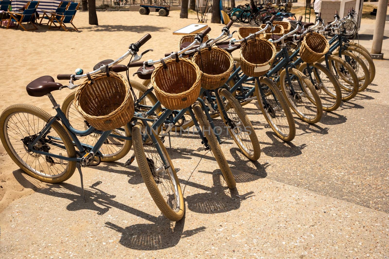 Row of Bicycles with Baskets on Beach. Bicycle Day. Lifestyle, Travel Destination, Vacation. Eco Transportation, Recreation. Horizontal Plane