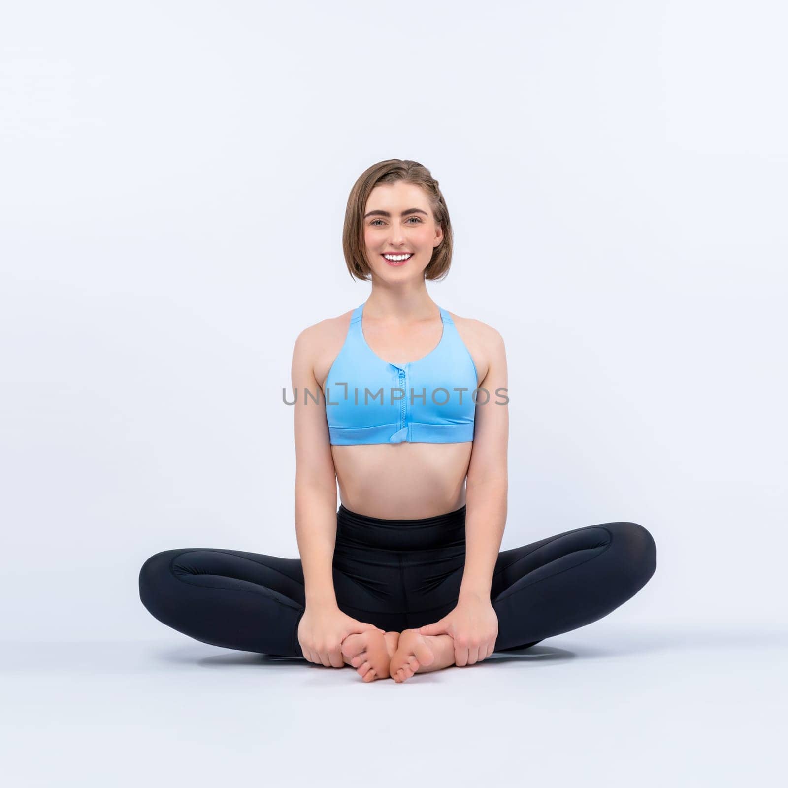 Full body length gaiety shot athletic and sporty woman doing yoga by biancoblue