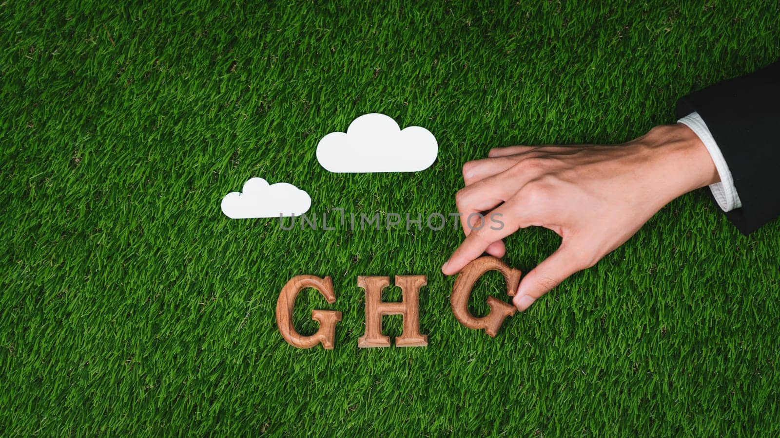 Hand arrange wooden alphabet text in GHG on biophilic background. Gyre by biancoblue