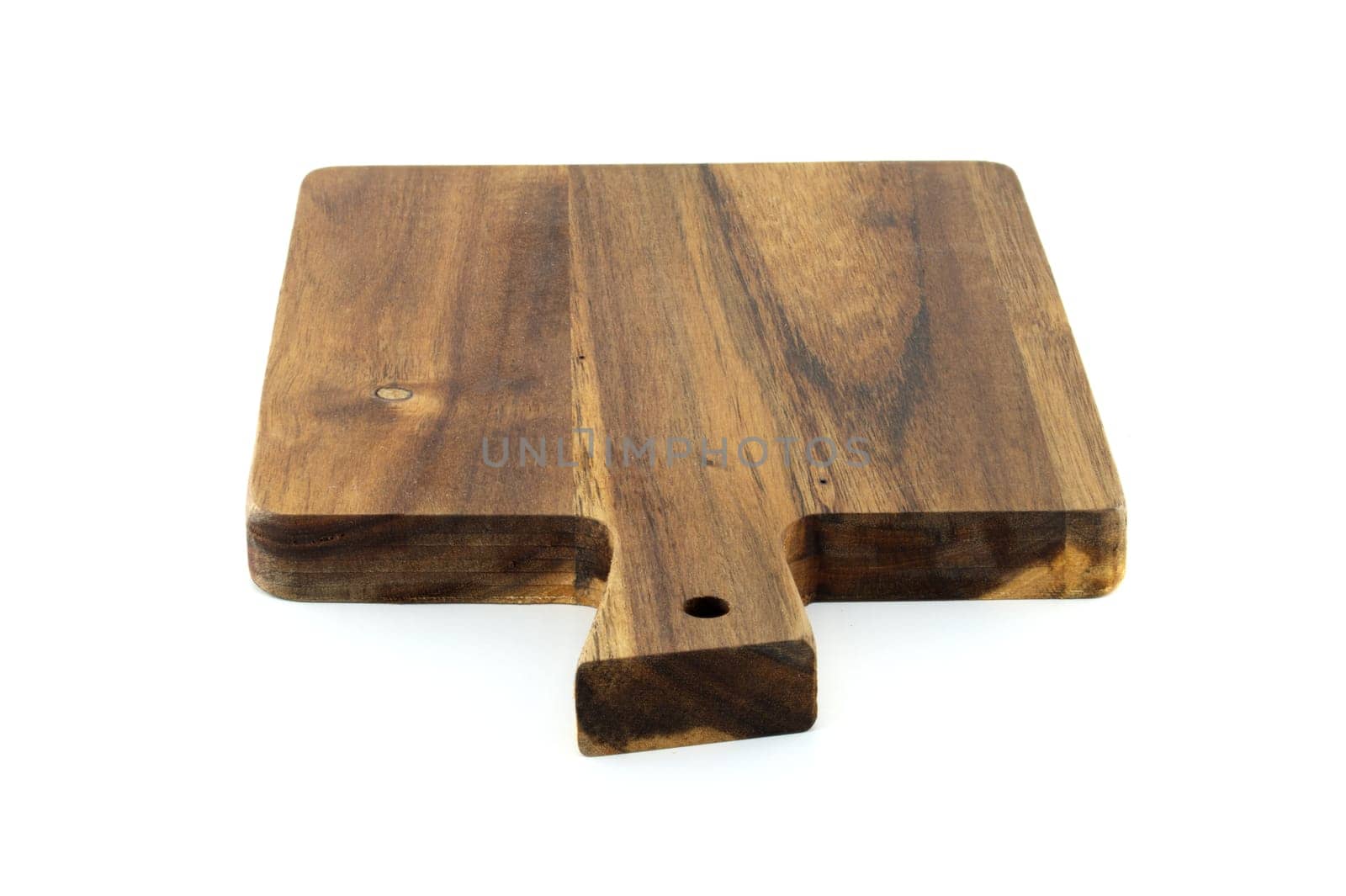 Wooden cutting board with a handle, made from old, thick wood, and bears a rustic, vintage appearance characterized by cracks, scratches, isolated on a white background