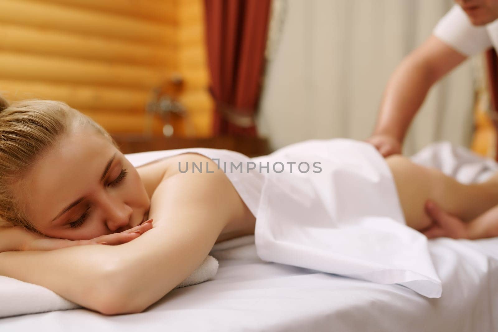 Spa. Portrait of relaxed young woman during massage
