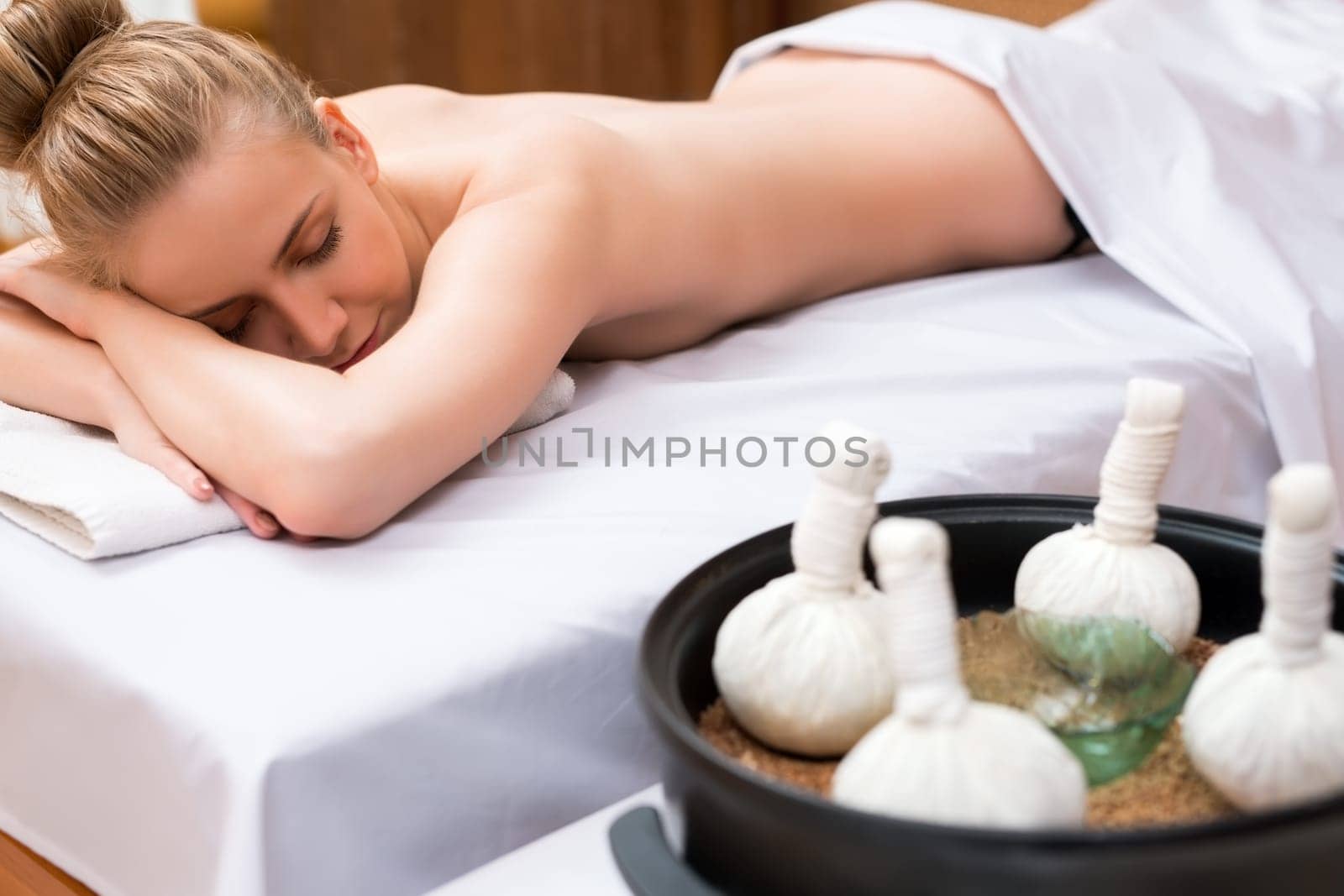 Traditional Thai massage with salt bags. Girl posing lying