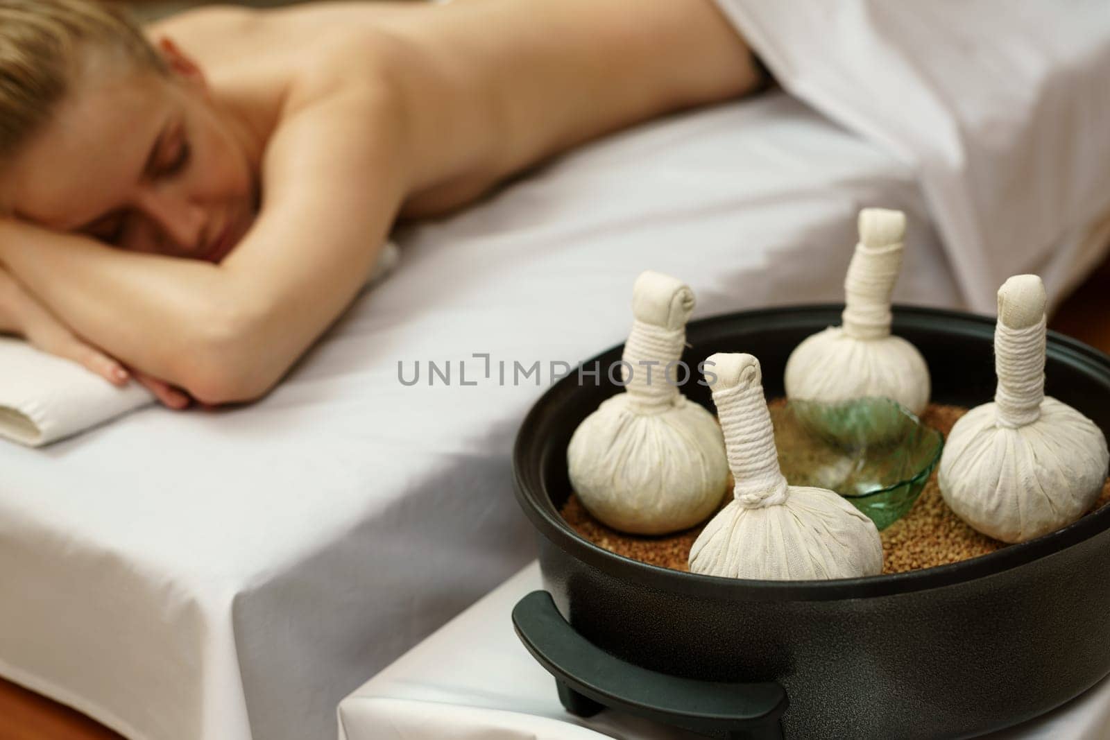 In spa center. Traditional thai massage with salt bags