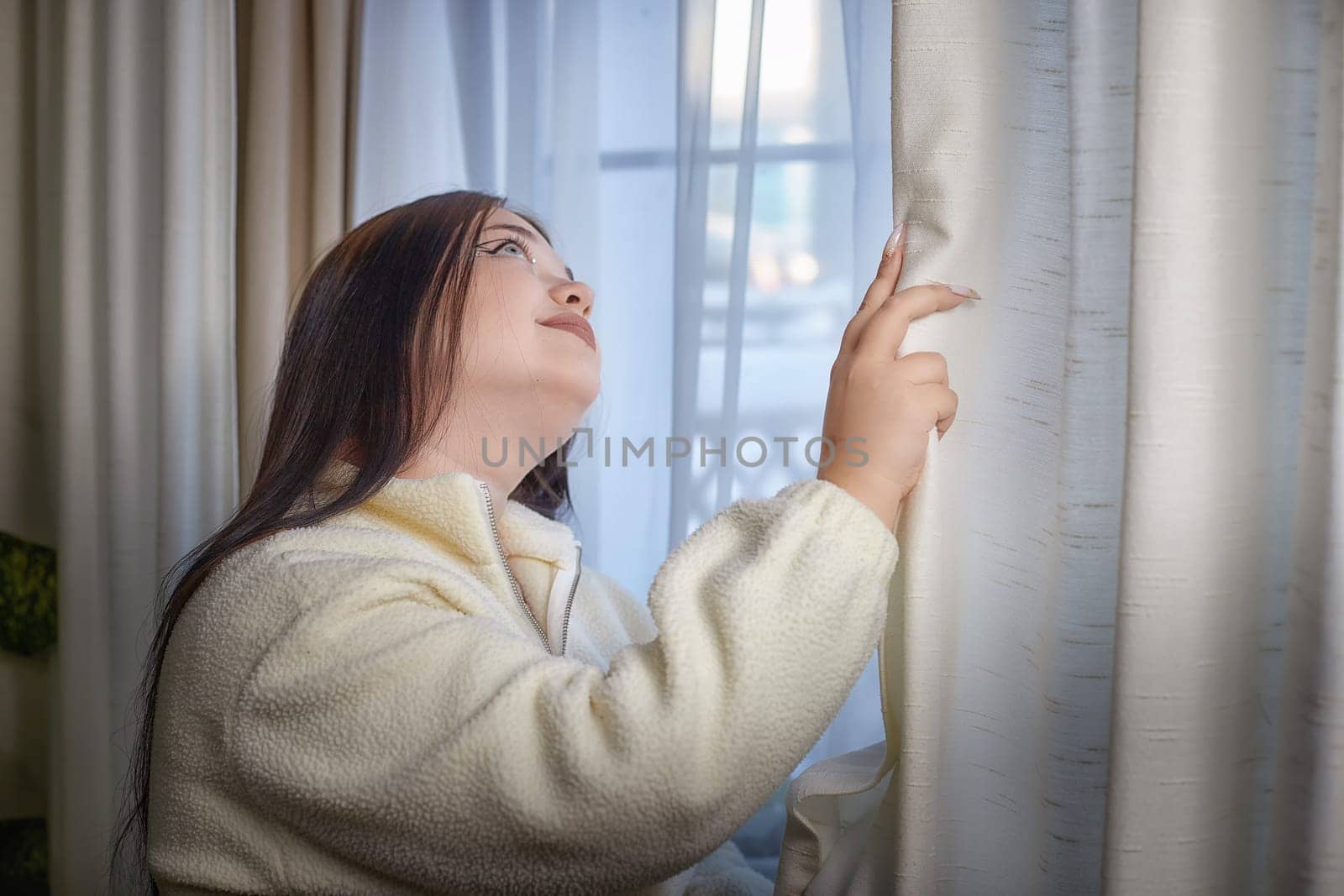 People and lifestyle concept. Body positiv. Indoor portrait of positive young Caucasian girl with chubby cheeks enjoying at home, smiling happy