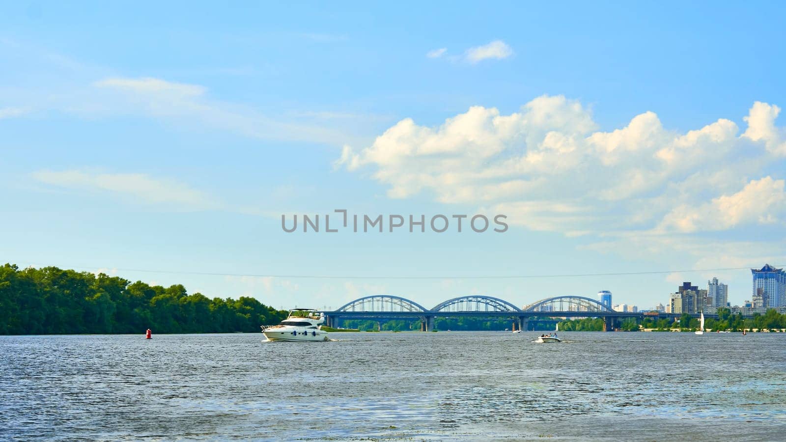 Sunny summer warm river.Bridge, urban.Pleasure boats and yachts by jovani68