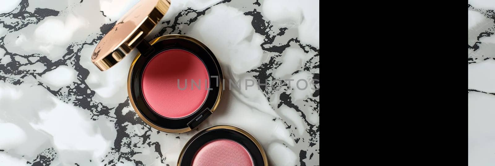 Close-up image of two compact cases with powder and blush on a white marble surface.